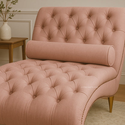 Pink tufted chair with a cylindrical backrest in a room setting.