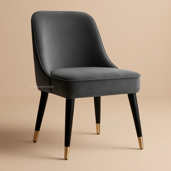 Gray chair with black legs and gold foot caps on a beige background