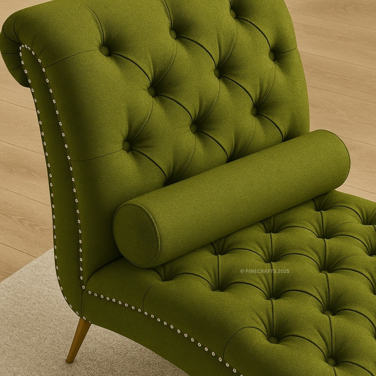 Green tufted chair with decorative nailhead trim on a wooden floor.
