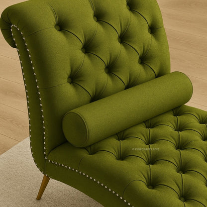 Green tufted chair with decorative nailhead trim on a wooden floor.