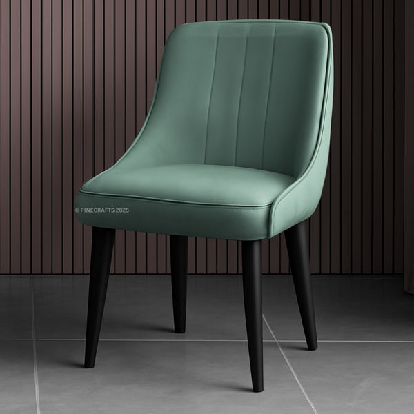 Green chair with black legs on a dark background
