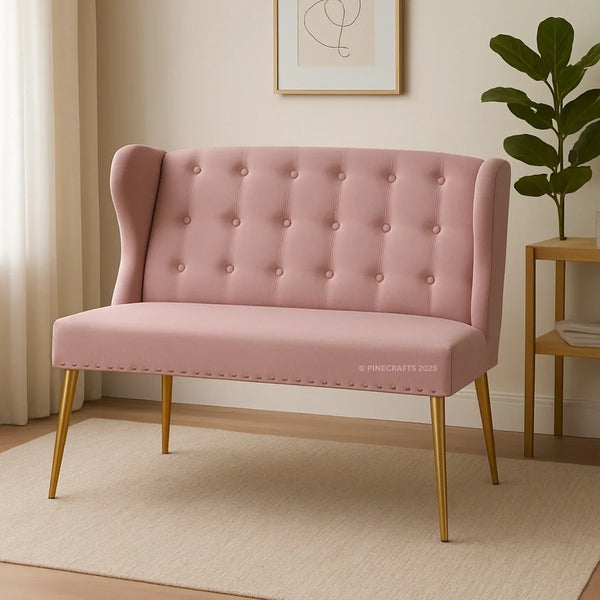 Pink tufted bench with gold legs in a room setting