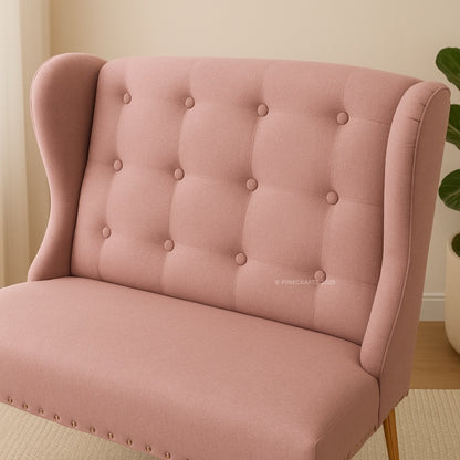 Pink tufted chair with button details in a room setting