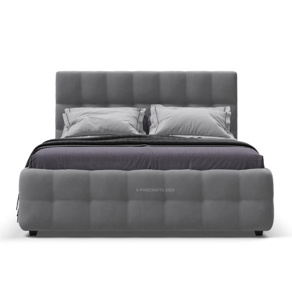Gray upholstered bed with pillows on a white background