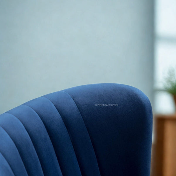 Close-up of a blue upholstered chair with a blurred background
