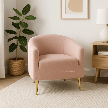 Pink armchair in a room with a plant and side table.
