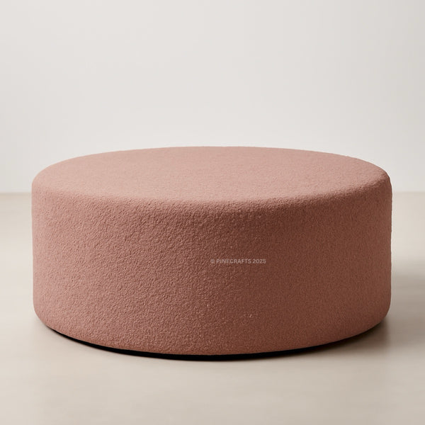 Round pink cushion on a beige background