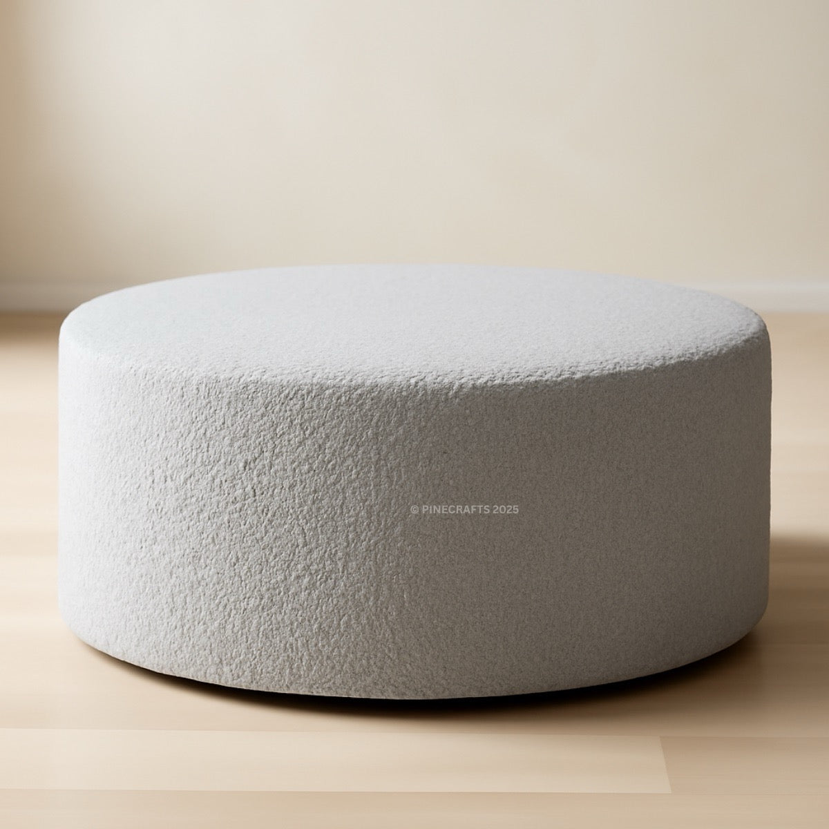 Round gray cushion on a beige floor with a neutral background