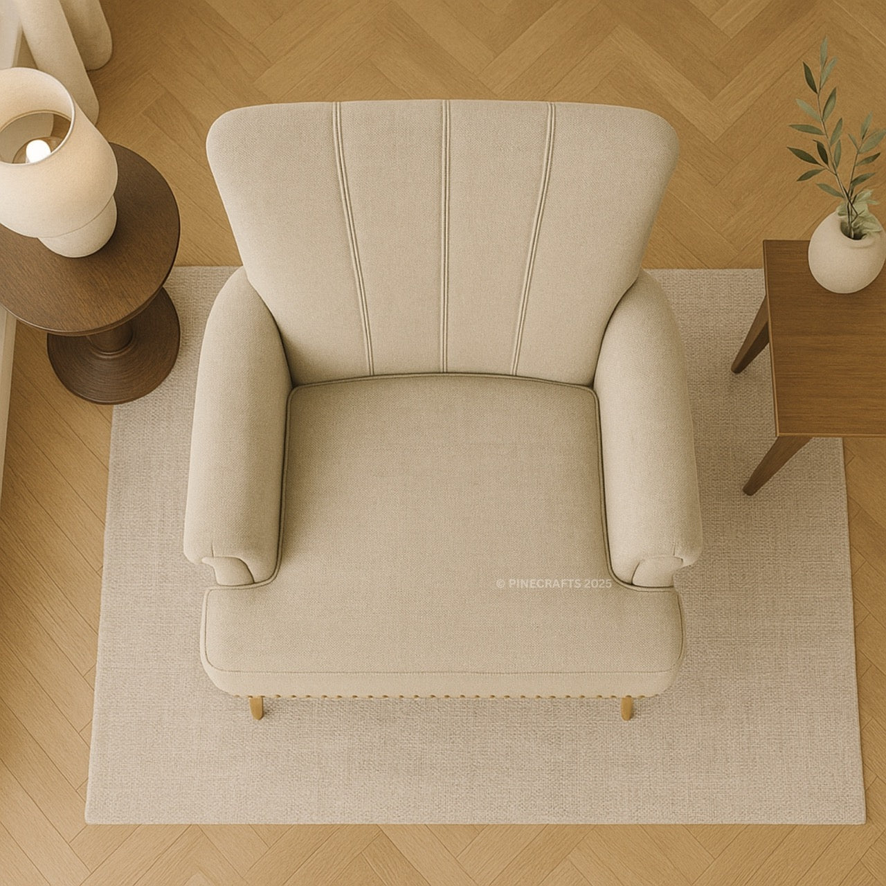 Beige armchair in a room with wooden floor and side tables.