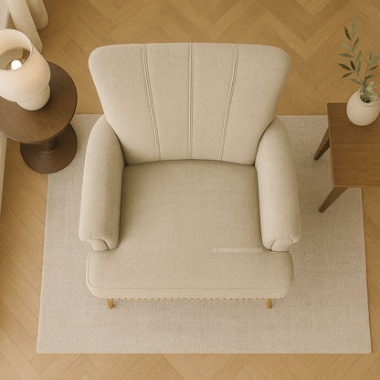 Beige armchair in a room with wooden floor and side tables.