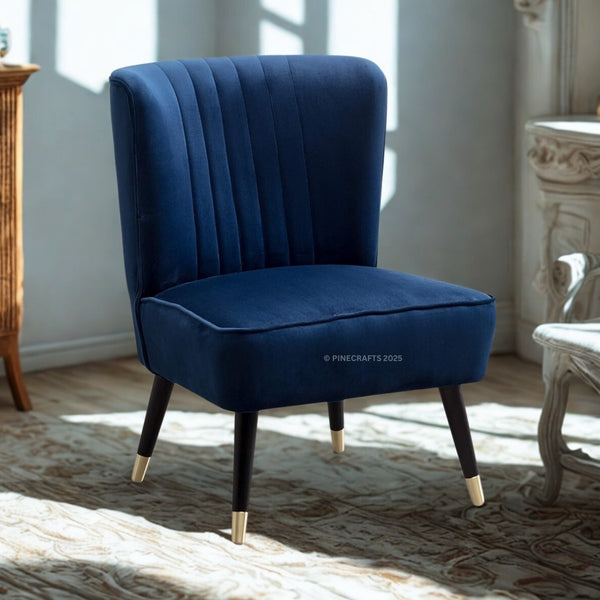 Blue velvet chair with gold feet in a sunlit room