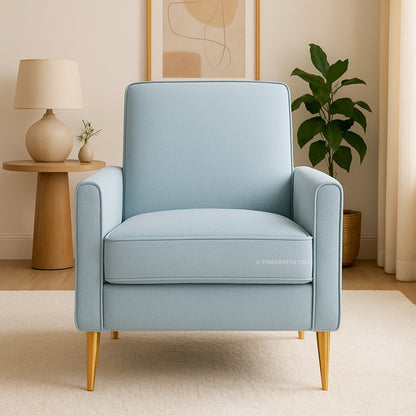 Light blue armchair in a room with a lamp, plant, and abstract art on the wall.