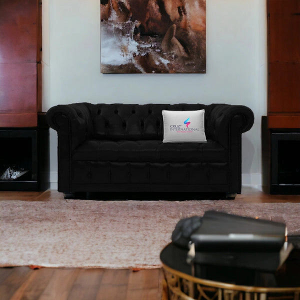 Black tufted sofa with CRUZ INTERNATIONAL pillow in modern living room, luxury furniture india