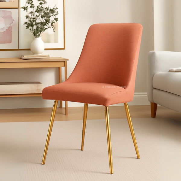 Orange chair with gold legs in a living room setting
