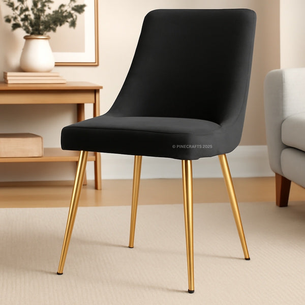 Black chair with gold legs in a room setting