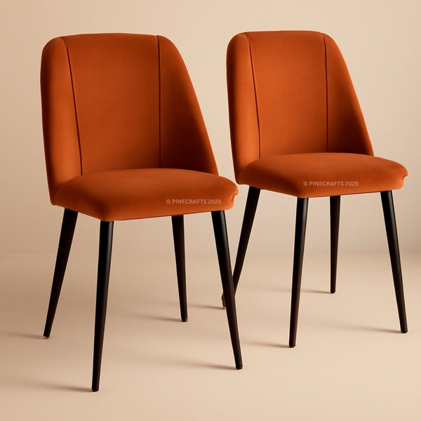 Two orange chairs with black legs on a beige background