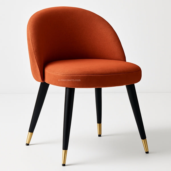 Orange chair with black legs and gold foot caps on a white background