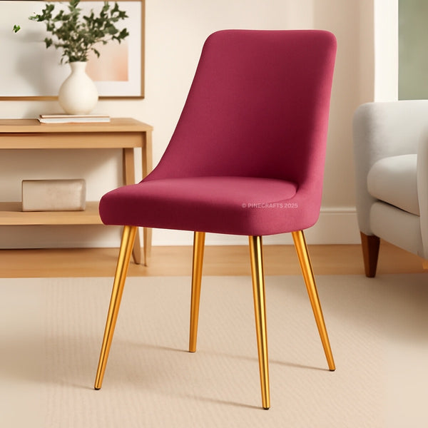 Pink chair with gold legs in a room setting