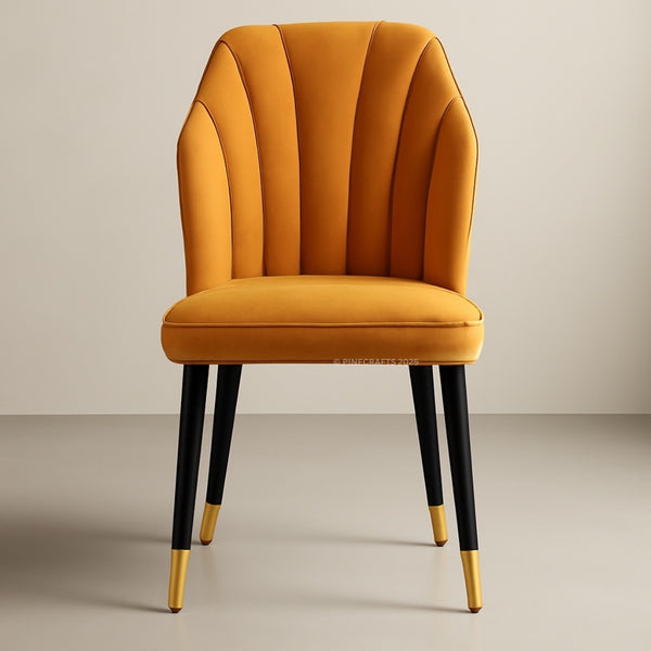 Mustard yellow chair with black legs and gold tips on a beige background