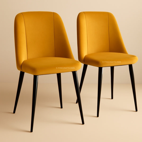 Two mustard yellow chairs with black legs on a beige background