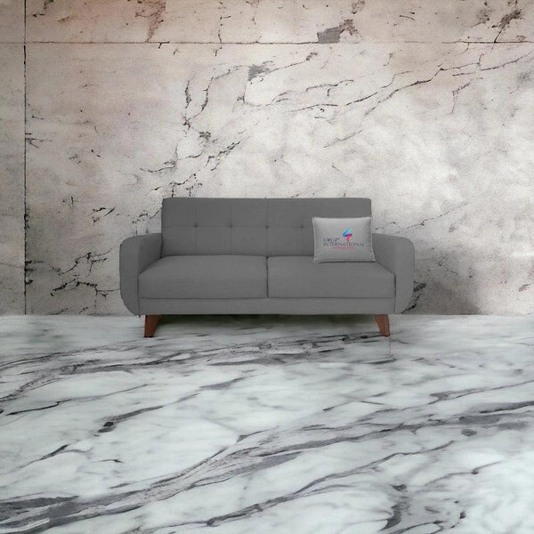 Modern grey sofa with CRUZ INTERNATIONAL pillow on marble floor and marble wall, furniture store