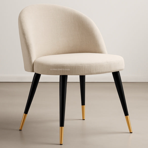 Beige chair with black legs and gold foot caps on a neutral background