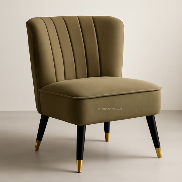 Green velvet chair with black legs and gold feet on a beige background