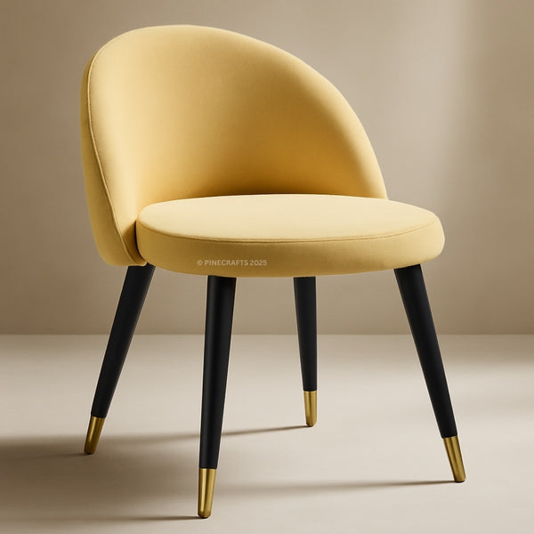 Yellow chair with black legs and gold tips on a beige background