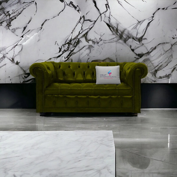 Olive green tufted sofa with CRUZ INTERNATIONAL pillow in modern marble living room setting.