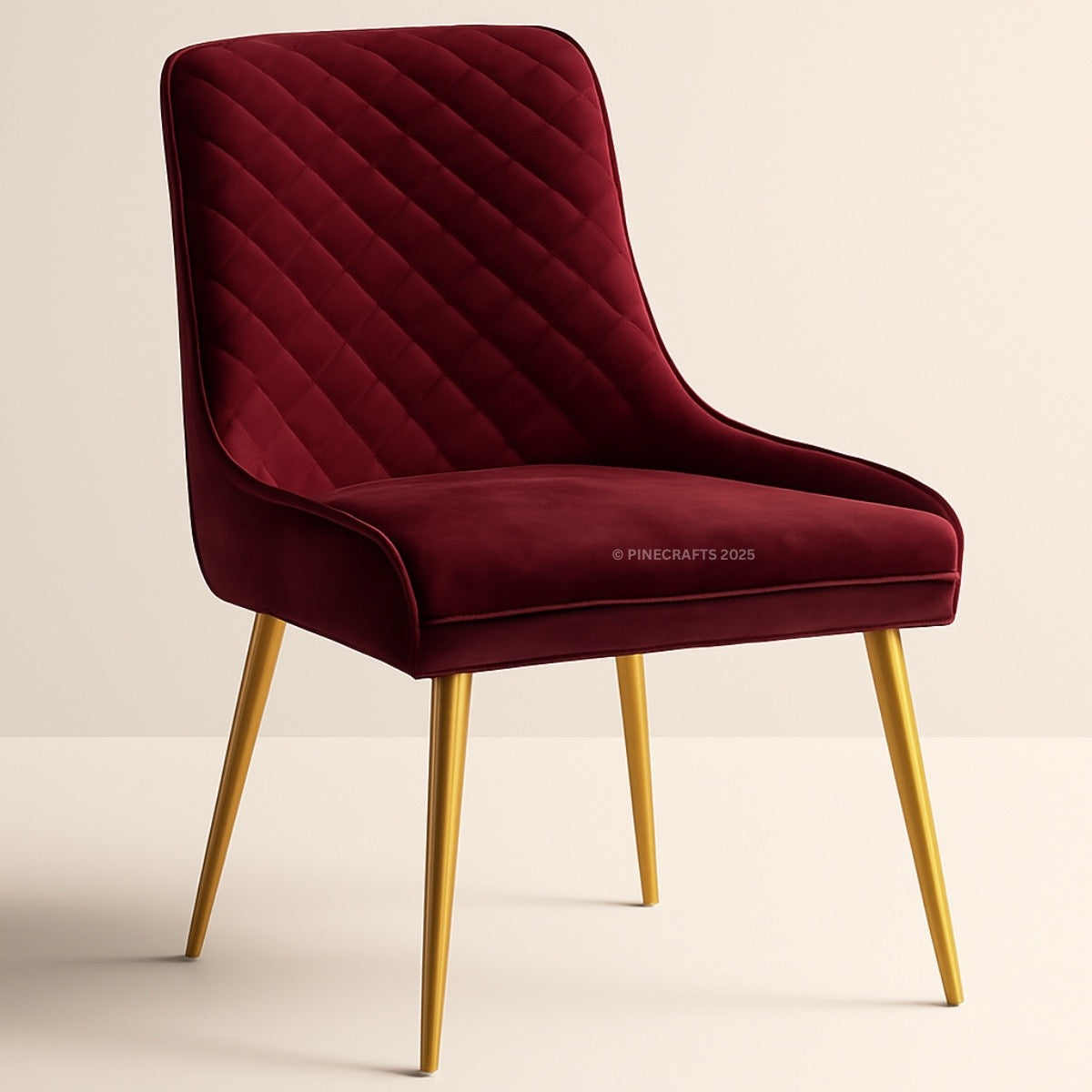 Maroon velvet chair with gold legs on a beige background