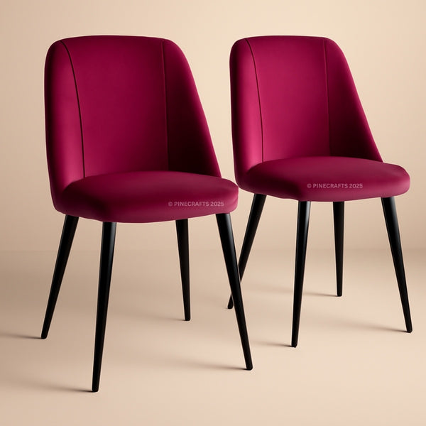 Two magenta chairs with black legs on a beige background