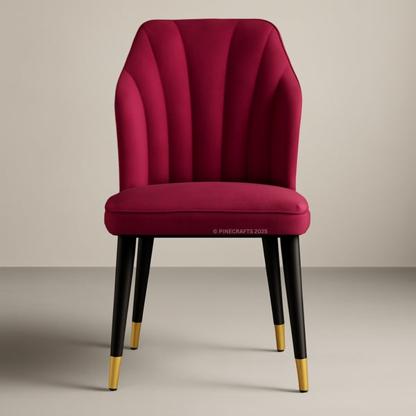 Red chair with black legs and gold tips on a beige background