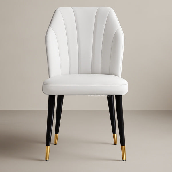 White chair with black legs and gold tips on a beige background