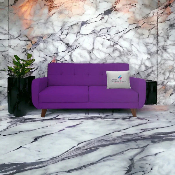 Modern purple sofa with CRUZ INTERNATIONAL cushion on marble floor and wall, indoor setting