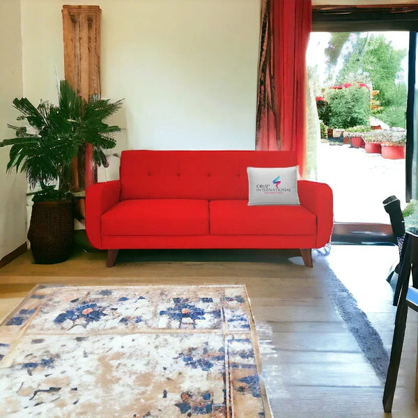 Modern red sofa with CRUZ INTERNATIONAL pillow in stylish living room with indoor plant and rug