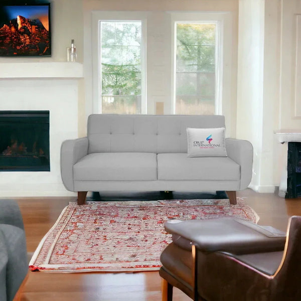 Modern living room with a light grey sofa from CRUZ INTERNATIONAL on a red patterned rug