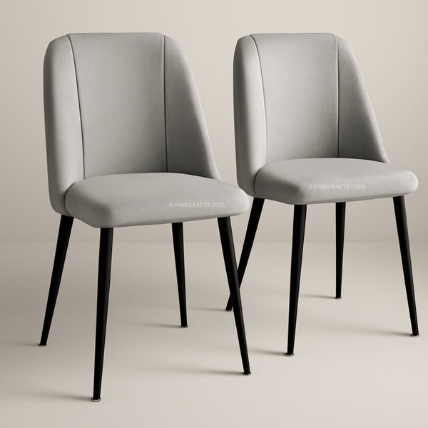 Two gray chairs with black legs on a beige background