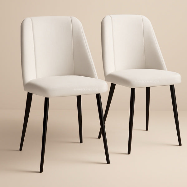 Two white chairs with black legs on a beige background